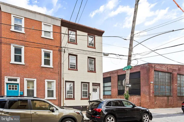 a view of a car parked in front of a building