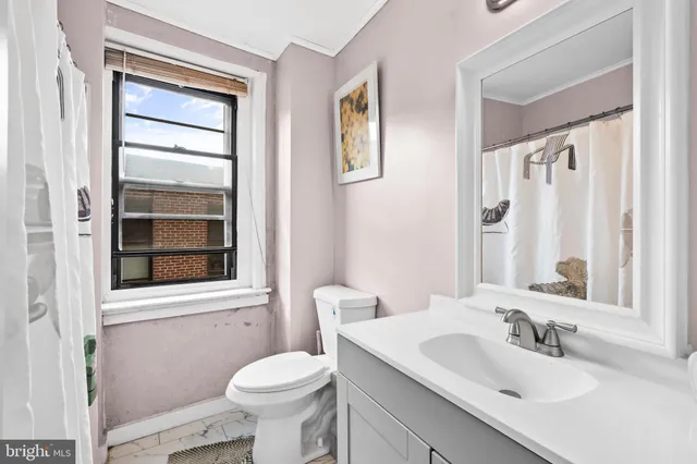 a bathroom with a sink toilet and mirror