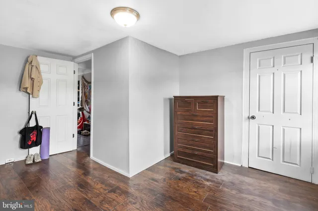 a view of an empty room with closet and a window