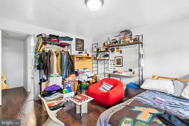 a bedroom with furniture and a book shelf