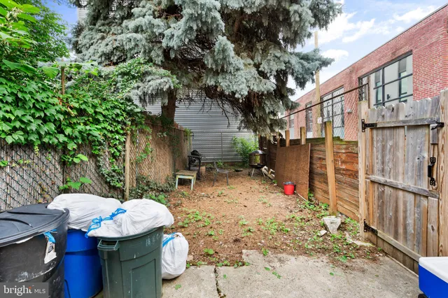 a backyard of a house with fire pit and chairs