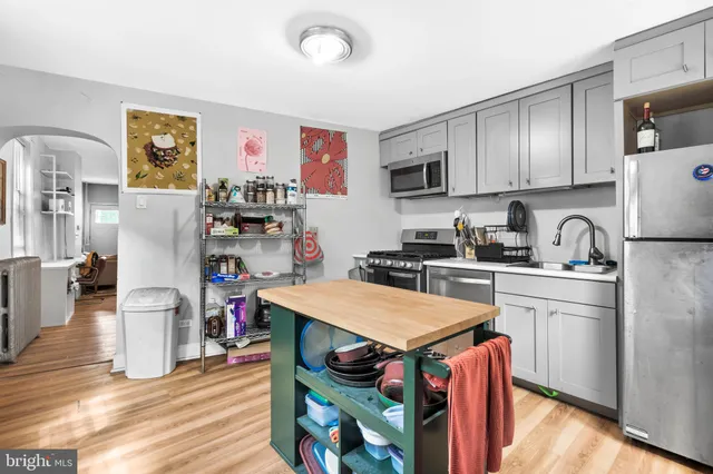 a kitchen with stainless steel appliances granite countertop a refrigerator and stove top oven