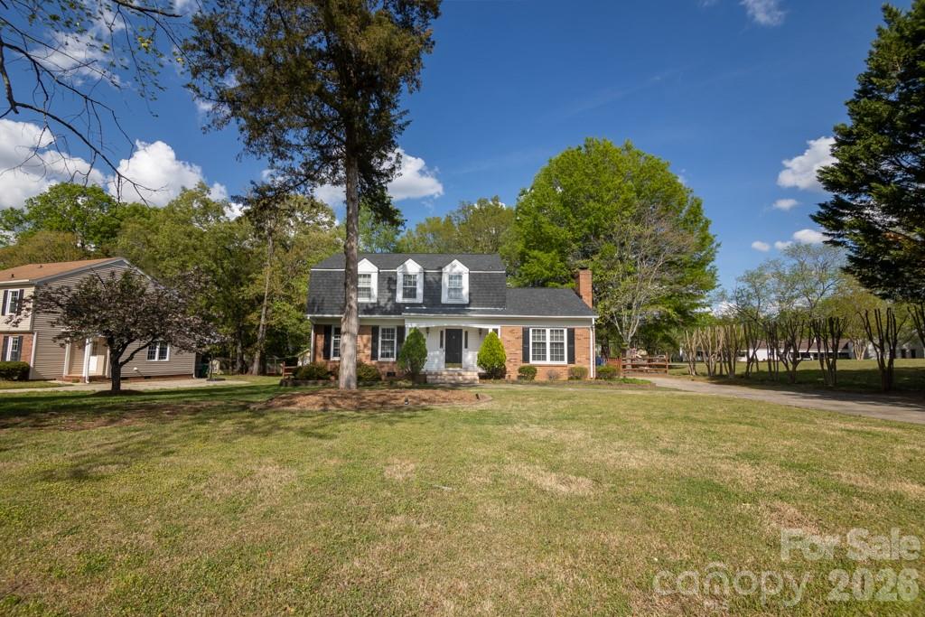 2232 Lawton Bluff Road Charlotte, NC 28226 - Photo 1 of 42 a front view of a house with a garden and trees