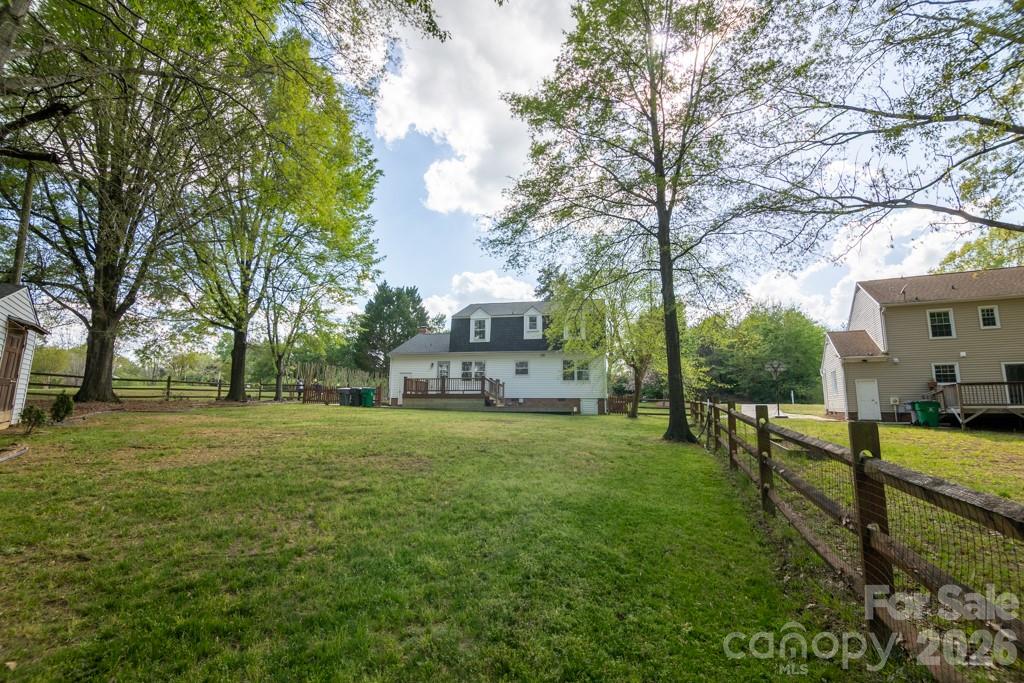 2232 Lawton Bluff Road Charlotte, NC 28226 - Photo 12 of 42 a view of a white house in front of a big yard with large trees