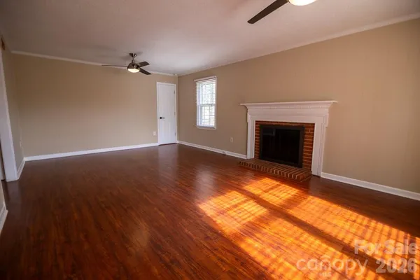 wooden floor in an empty room with a fireplace