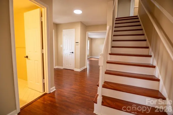 a view of entryway and hall with wooden floor