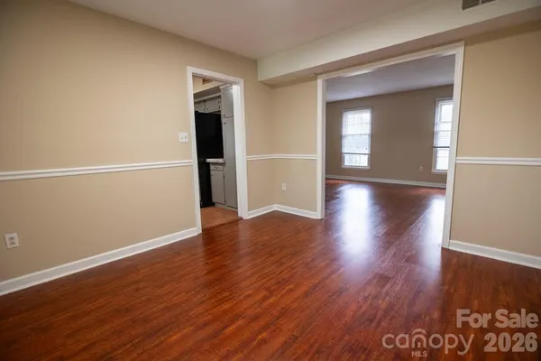a view of a room with wooden floor and window