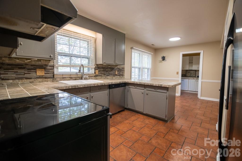 2232 Lawton Bluff Road Charlotte, NC 28226 - Photo 23 of 42 a kitchen with stainless steel appliances granite countertop a sink stove and cabinets