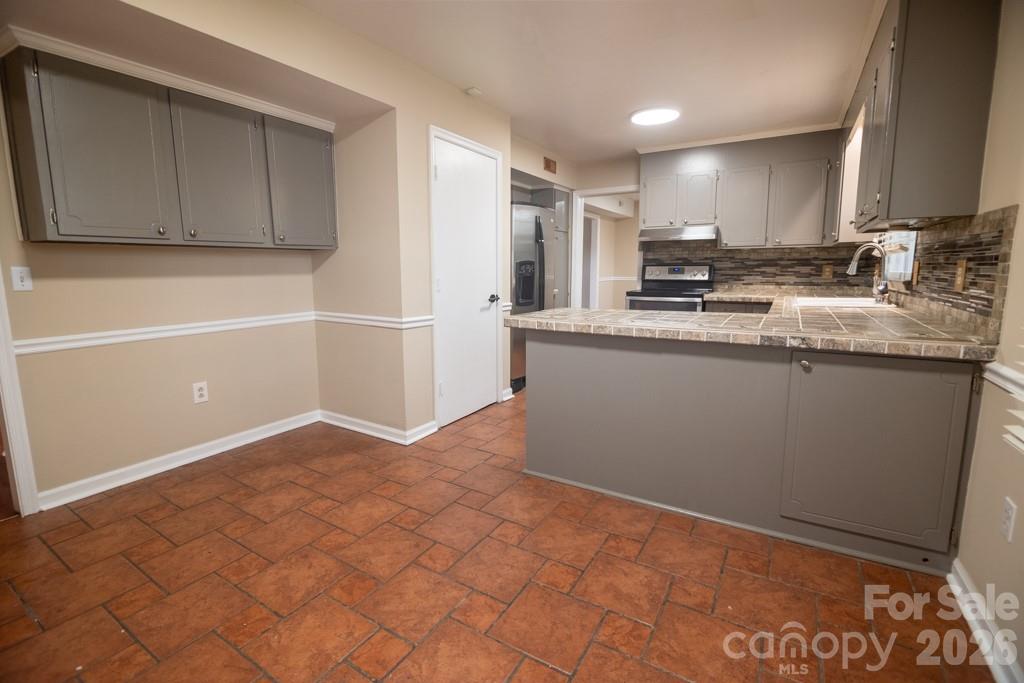 2232 Lawton Bluff Road Charlotte, NC 28226 - Photo 26 of 42 a kitchen with stainless steel appliances granite countertop a sink and cabinets