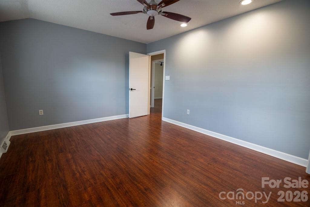 2232 Lawton Bluff Road Charlotte, NC 28226 - Photo 30 of 42 an empty room with wooden floor and windows