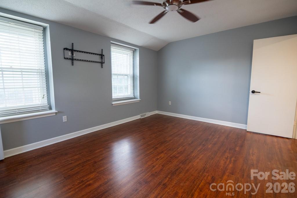 2232 Lawton Bluff Road Charlotte, NC 28226 - Photo 31 of 42 a view of an empty room with wooden floor and a window