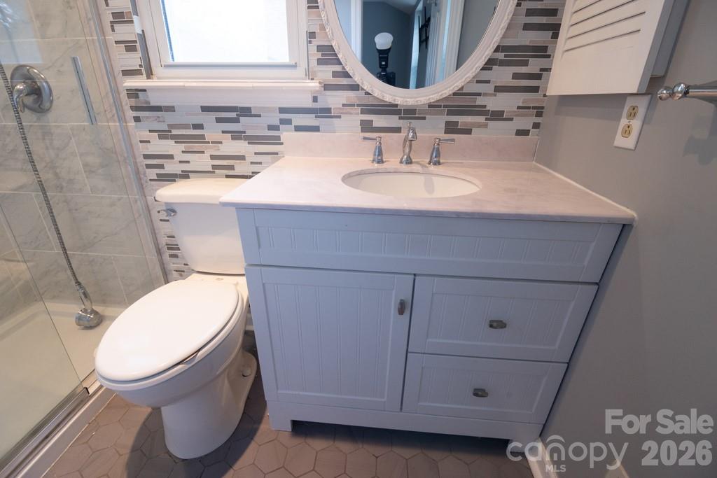 2232 Lawton Bluff Road Charlotte, NC 28226 - Photo 33 of 42 a bathroom with a toilet a sink and mirror