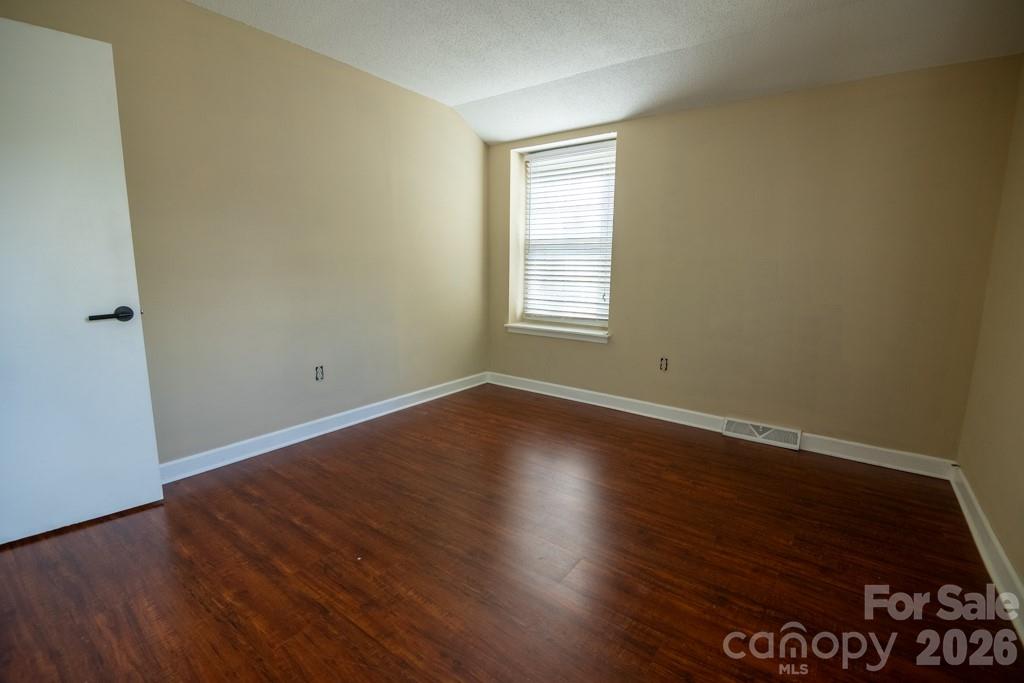 2232 Lawton Bluff Road Charlotte, NC 28226 - Photo 35 of 42 an empty room with wooden floor and windows