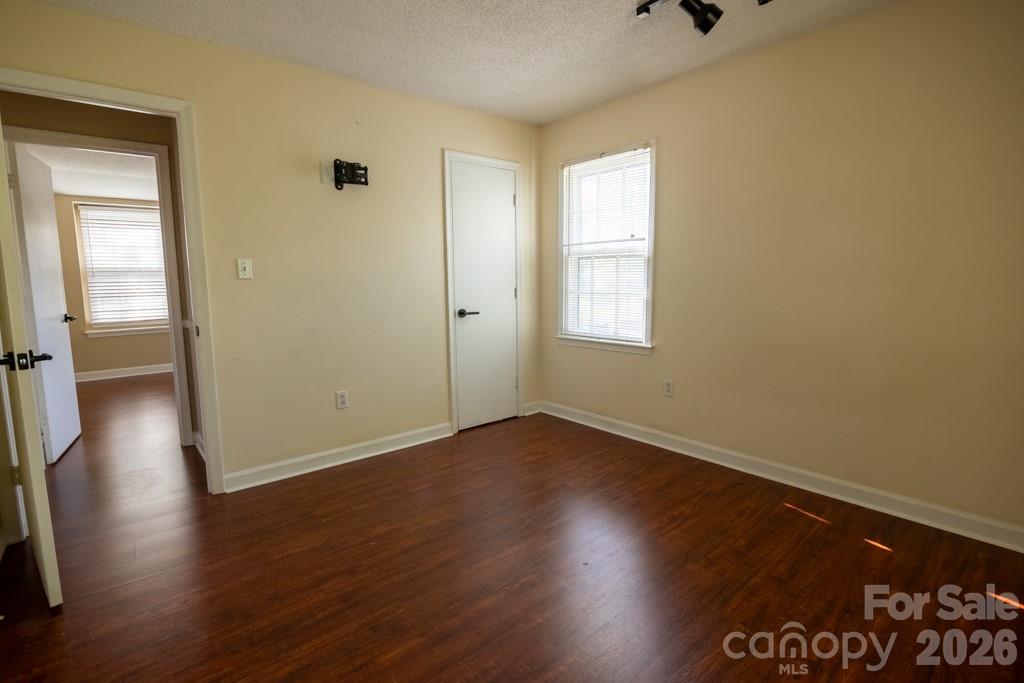 2232 Lawton Bluff Road Charlotte, NC 28226 - Photo 37 of 42 an empty room with wooden floor and windows