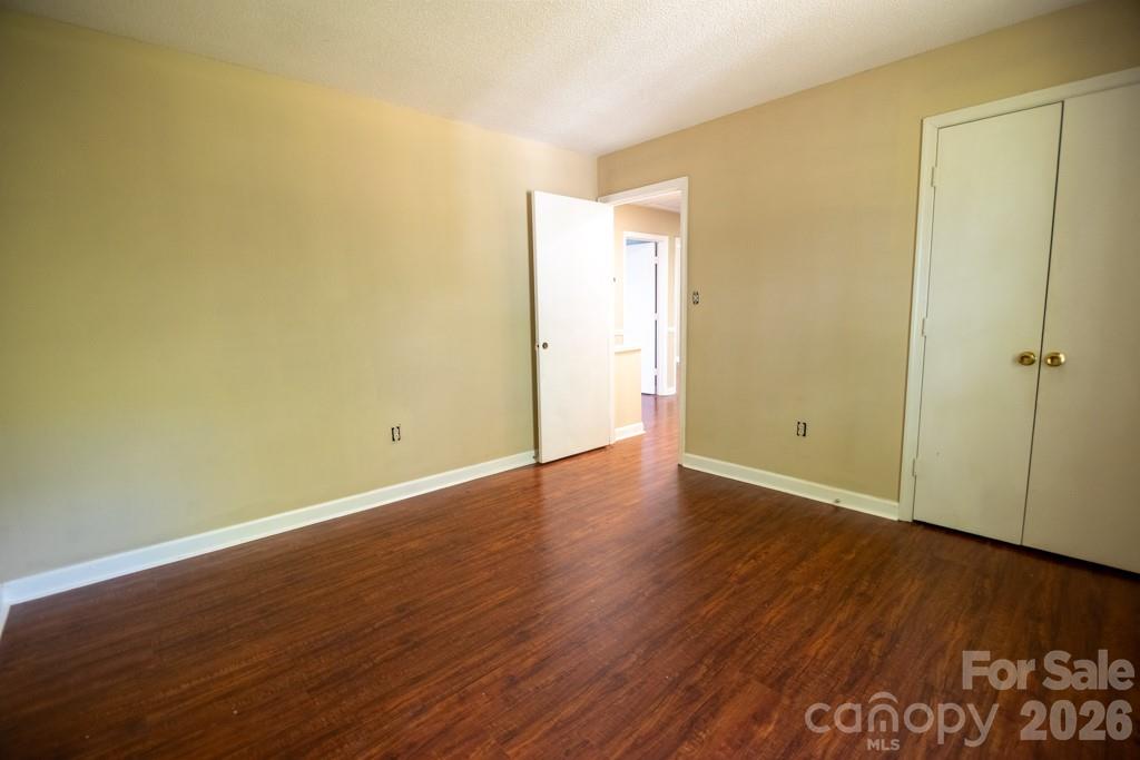 2232 Lawton Bluff Road Charlotte, NC 28226 - Photo 39 of 42 a view of an empty room with wooden floor and a window
