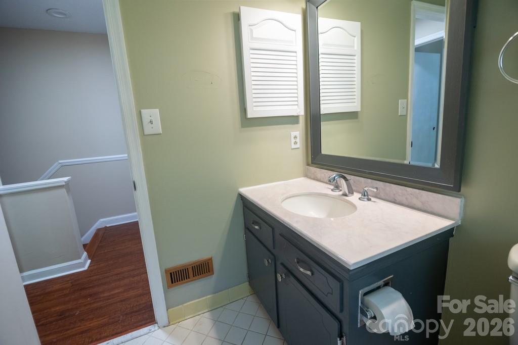 2232 Lawton Bluff Road Charlotte, NC 28226 - Photo 42 of 42 a bathroom with a sink and a mirror