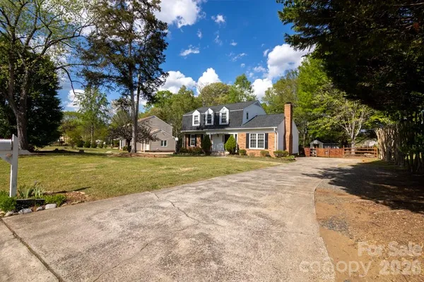 a front view of house with yard and trees