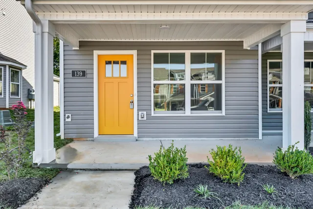 a front view of a house with a yard