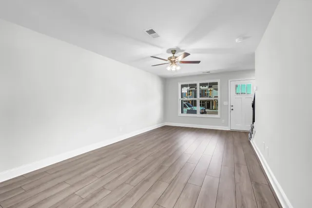 wooden floor in an empty room with a window