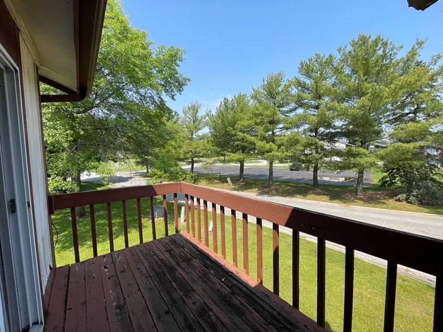 a view of a wooden deck with a yard