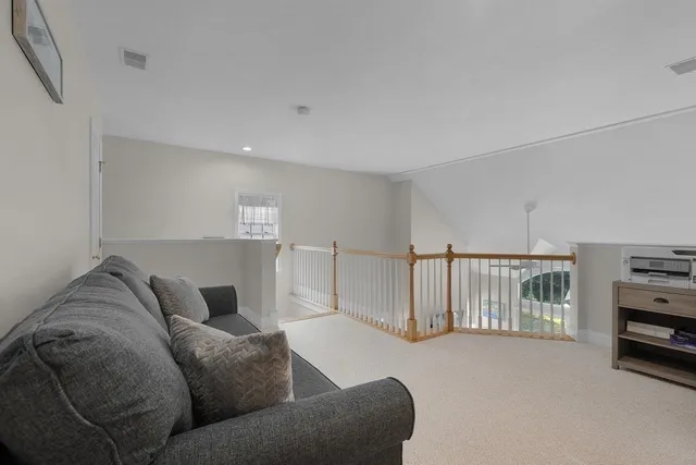 a living room with furniture a flat screen tv and a window