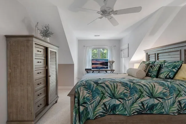 a bedroom with a bed dresser and a window