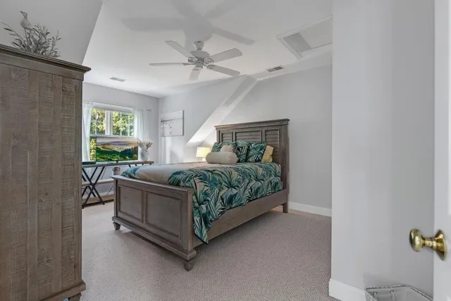 a bedroom with a bed couch and window