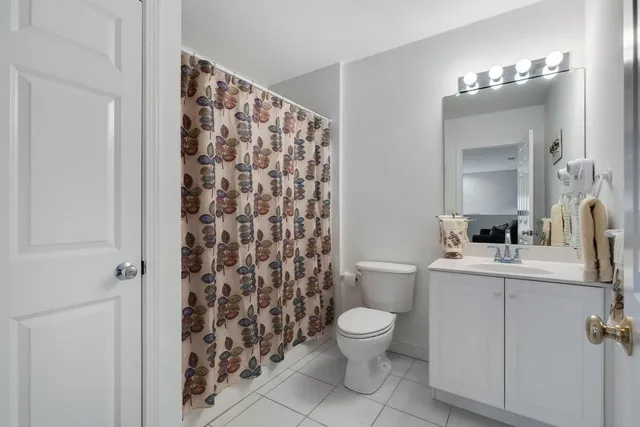 a white toilet sitting next to a bathroom sink