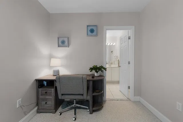 a view of a workspace with furniture and a potted plant