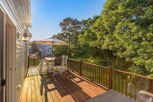 a view of balcony with wooden floor and outdoor seating