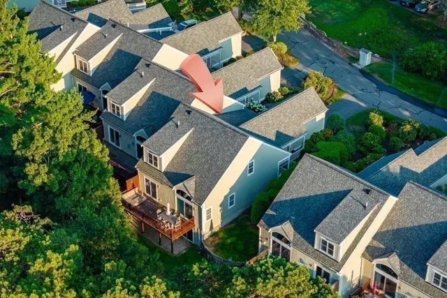an aerial view of a house with garden space and street view