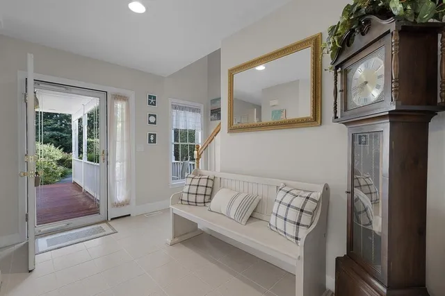 a living room with furniture and a painting on the wall