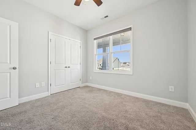 an empty room with windows and closet