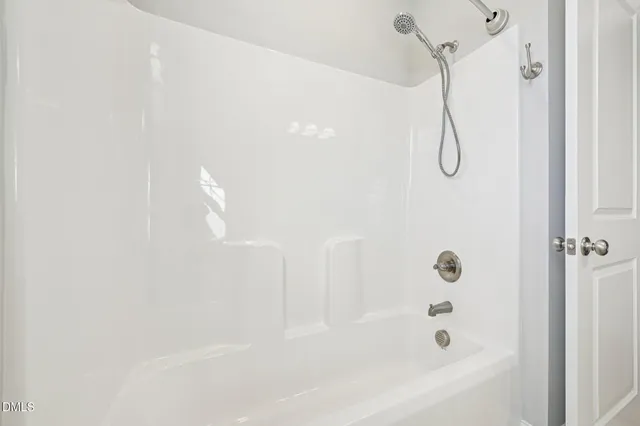 a bathroom with a bath tub with a shower
