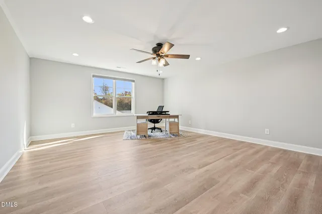 a view of a room with a window and wooden floor