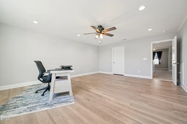 a workspace with wooden floor and a window