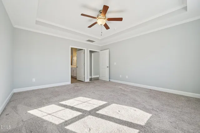 a view of a livingroom with a ceiling fan and window