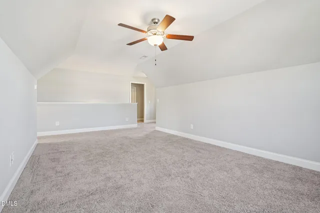 a living room with a floor to ceiling window and a table