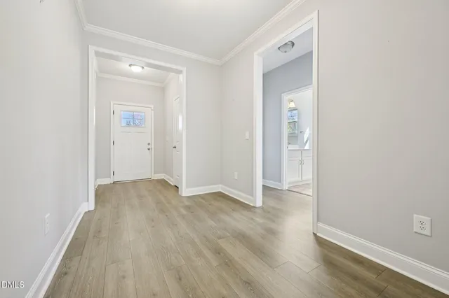 an empty room with wooden floor and closet