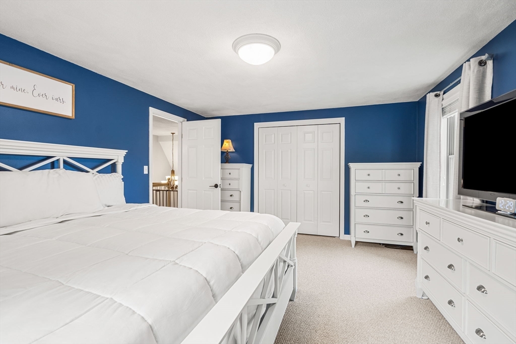 28 Andrews Farm Road Boxford, MA 01921 - Photo 21 of 42 a bedroom with a bed and a flat tv screen on dresser