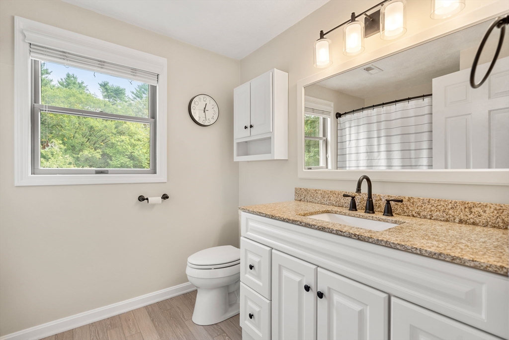 28 Andrews Farm Road Boxford, MA 01921 - Photo 27 of 42 a bathroom with a granite countertop sink toilet and a window