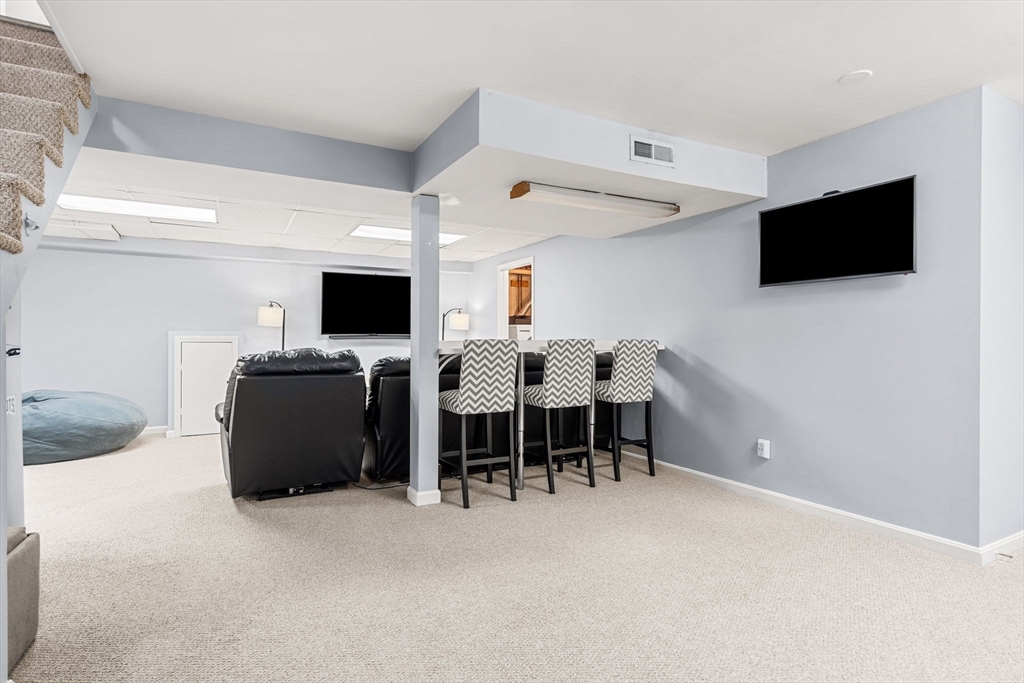 28 Andrews Farm Road Boxford, MA 01921 - Photo 29 of 42 a view of a livingroom with furniture and a flat screen tv