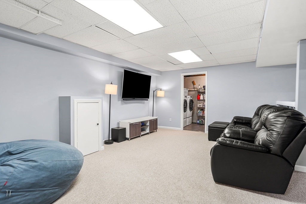 28 Andrews Farm Road Boxford, MA 01921 - Photo 32 of 42 a living room with furniture and a flat screen tv