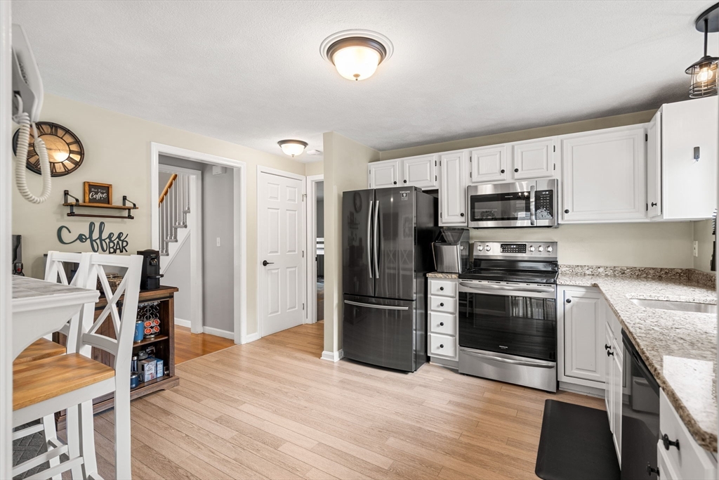 28 Andrews Farm Road Boxford, MA 01921 - Photo 8 of 42 a kitchen with stainless steel appliances granite countertop a refrigerator stove and sink