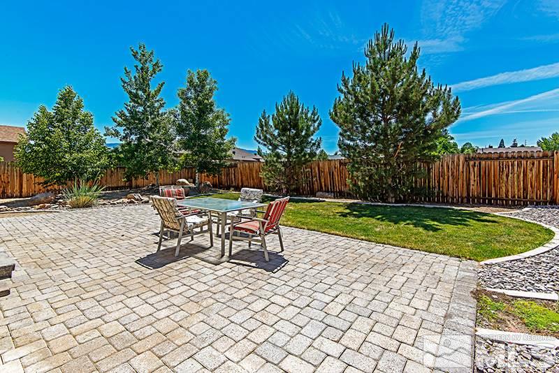 2916 Bryan Street Reno, NV 89503 - Photo 16 of 18 a view of a backyard with table and chairs with a fire pit and a potted plant