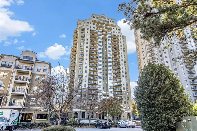 a bathroom with a granite countertop sink a toilet and a mirror