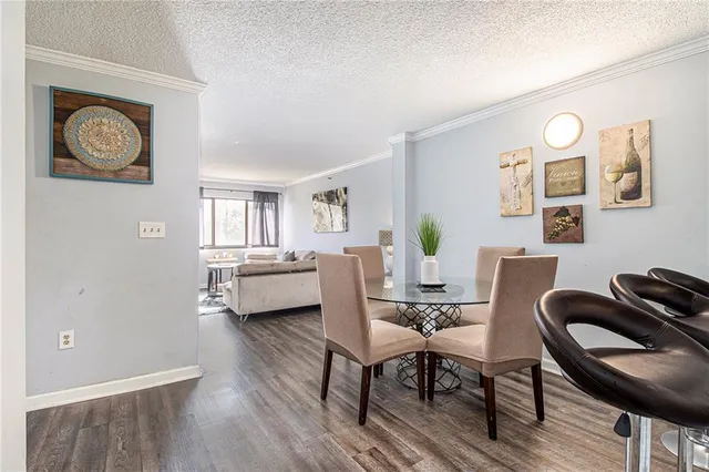 a view of a dining room with furniture a chandelier and wooden floor