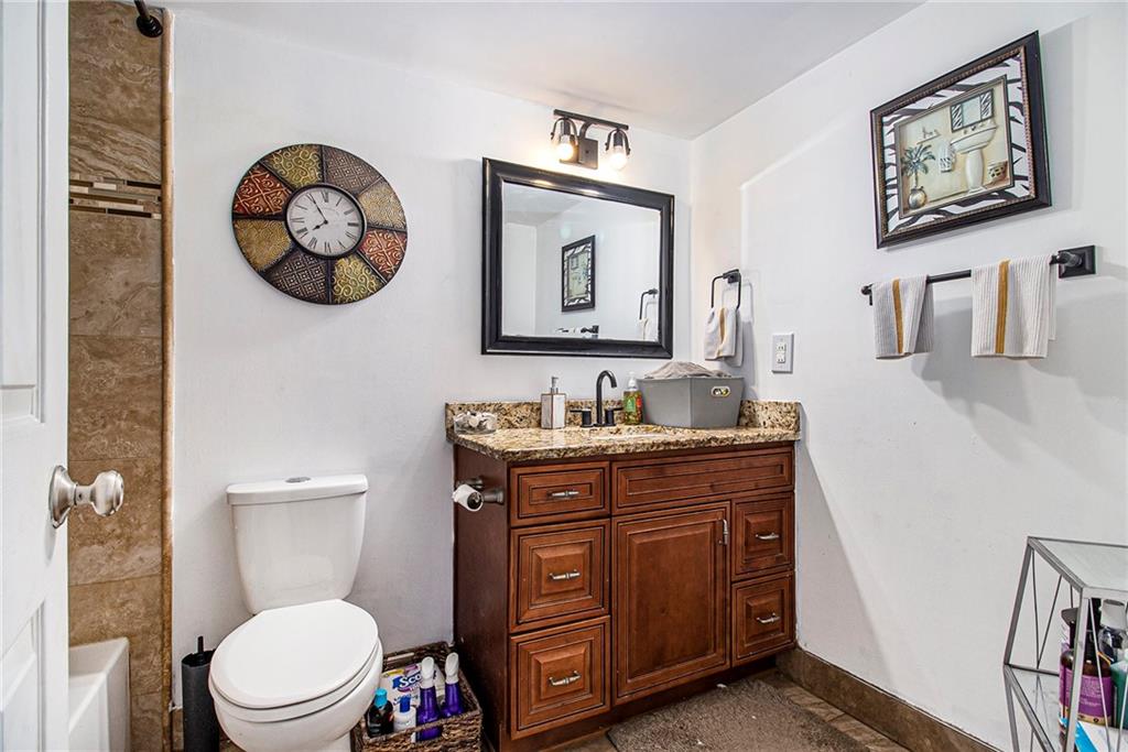 795 Hammond Drive, Unit 206 Atlanta, GA 30328 - Photo 15 of 29 a bathroom with a toilet a sink and a mirror