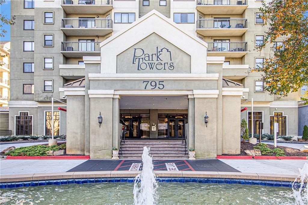 795 Hammond Drive, Unit 206 Atlanta, GA 30328 - Photo 17 of 29 a view of a building with retail shops and traffic signal