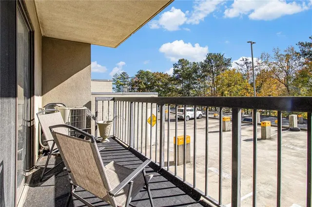 a view of a hallway with wooden floor and windows